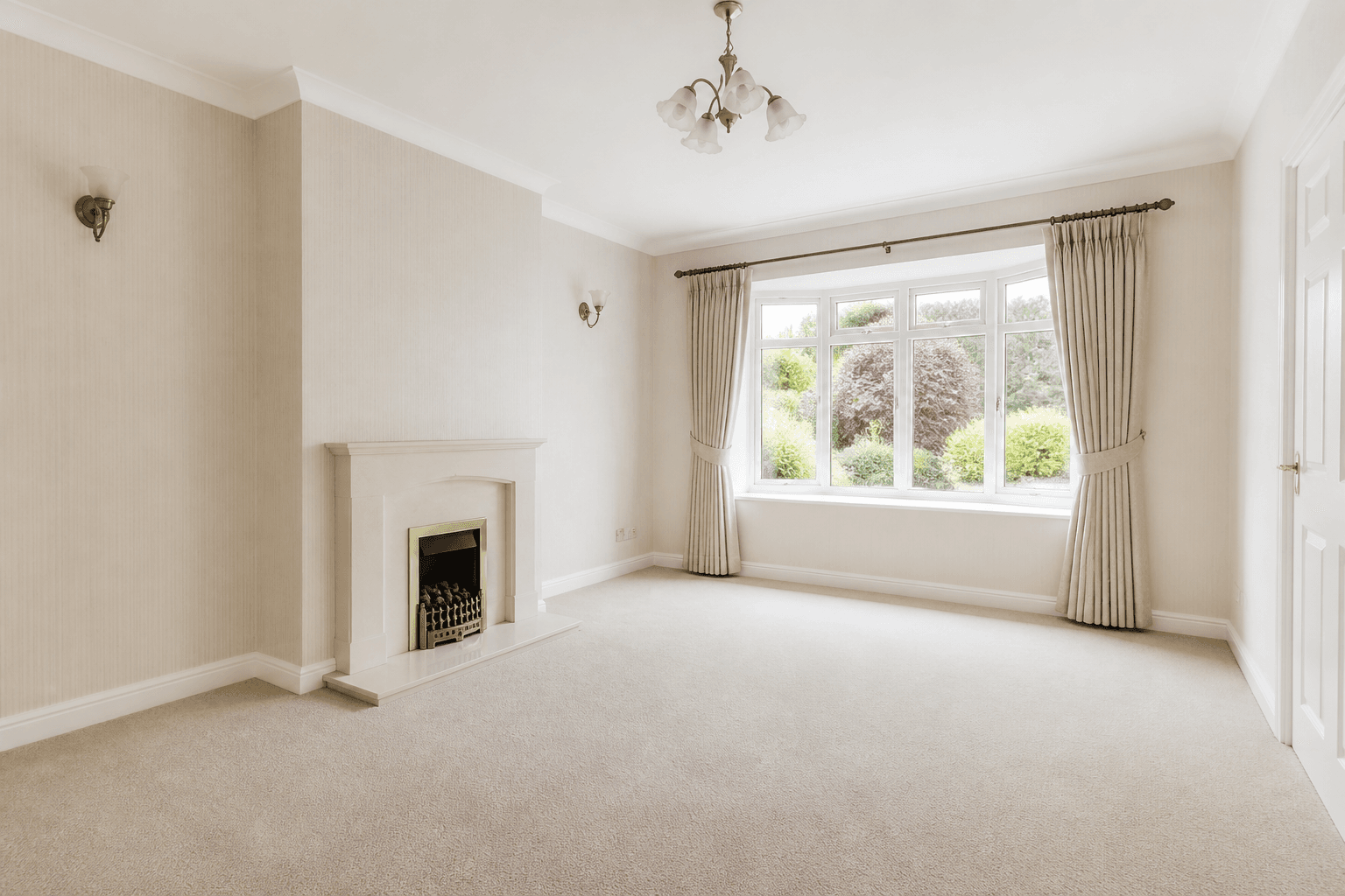Bright respectfully presented vacant UK living room prepared for probate sale photography with soft natural light